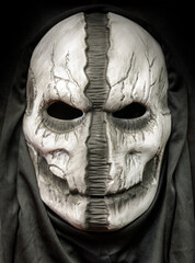 Death Hood Mask With Face Ripped Down The Middle Isolated on Black Background