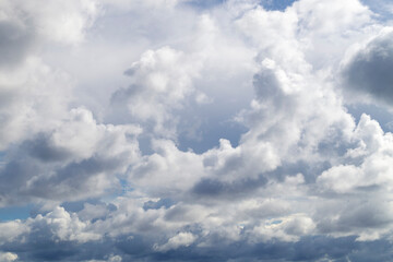 The blue sky shines through the clouds. Beautiful white cumulus clouds in the blue sky