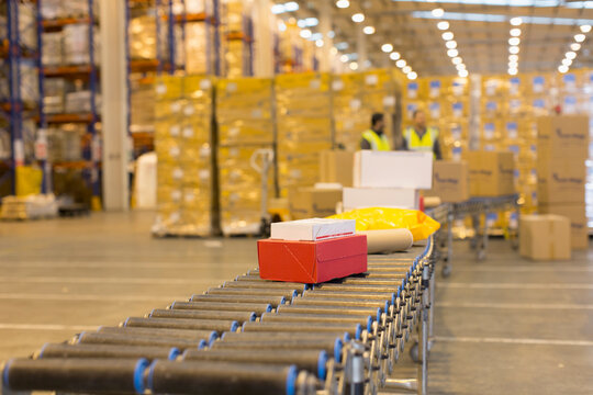 Packages on conveyor belt in distribution warehouse