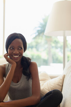 Portrait happy mischievous young woman on sofa