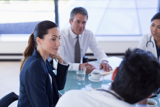 Attentive hospital administrator listening to doctors in meeting