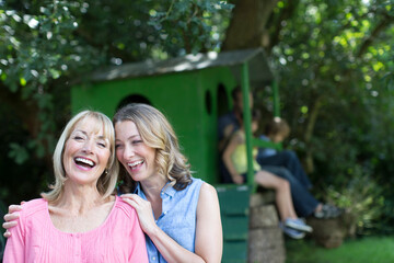 Fototapeta premium Portrait happy mother and daughter with family at treehouse