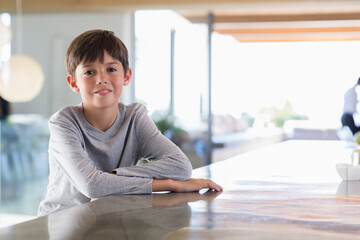 Portrait smiling boy at kitchen counter © Martin Barraud/Caia Image