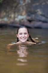 Fototapeta premium Portrait happy young woman swimming in lake