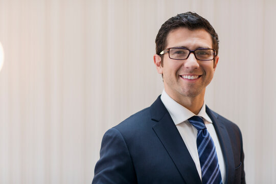 Portrait confident corporate businessman in suit and eyeglasses
