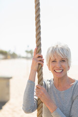Portrait happy senior woman exercising at rope © Sam Edwards/Caia Image