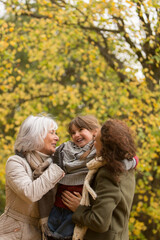 Fototapeta premium Happy multi-generation family in autumn park