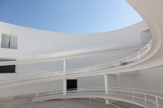 Winding ramps in modern building courtyard
