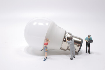 Business creative idea, power or energy generator concept, miniature people