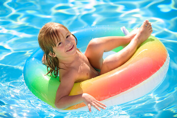 Child in swimming pool. Kids in swimming pool.