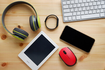 White keyboard with wireless mouse and bluetooth wireless headphones and other electronic gadgets...