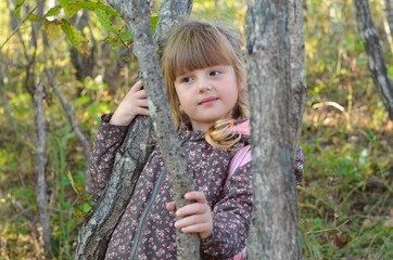 Beautiful portrait caucasian child in autumn forest