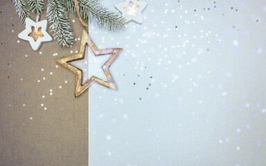 decorative wooden christmas star and frosty fir branch with star holiday lights on two color background