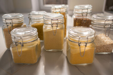 Collection of grain productsin storage jars over on kitchen. Jar of cereals in kitchen cupboard