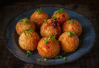 Traditional Italian arancini (rice balls with Mozzarella cheese) 