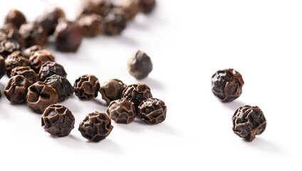 Black peppercorns isolated on white background.