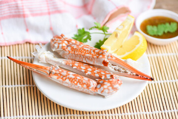 Boiled crab food on white plate and seafood sauce on the table - crab claws shellfish