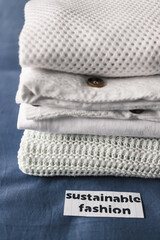 fair trade concept, pile of clothing with Sustainable Fashion label