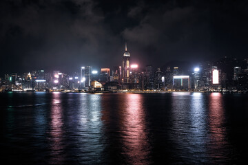 Fototapeta premium Hong Kong Skyline by night photography. This photo shows Hong Kong Island side in the early night time when all the lights are on.