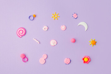 Abstract purple pastel background with kids accessories from clay, Concept of pop art culture, 80s,...