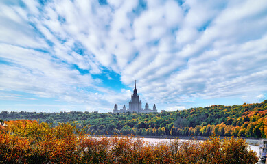 Silhouette of famous Russian university in early autumn day near Moscow river under blue sky