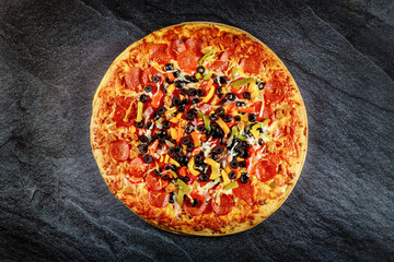 Supreme pizza with black olives and pepperoni. Close up.