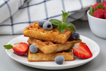 Sweet Belgian waffles with fresh berries. Delicious breakfast. Selective focus