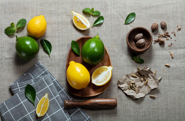 lemons with limes and slices on canvas background