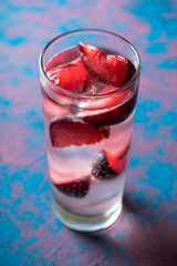 Autumn cocktail with red plums. Selective focus. Shallow depth of field.