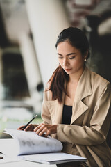 Young beautiful businesswoman concentrate on her project in modern office room.