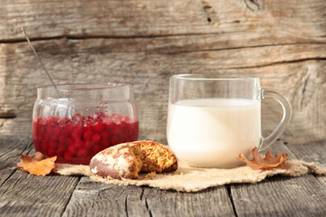 Morning breakfast with ginger bread,dairy products and egg on a wooden background.