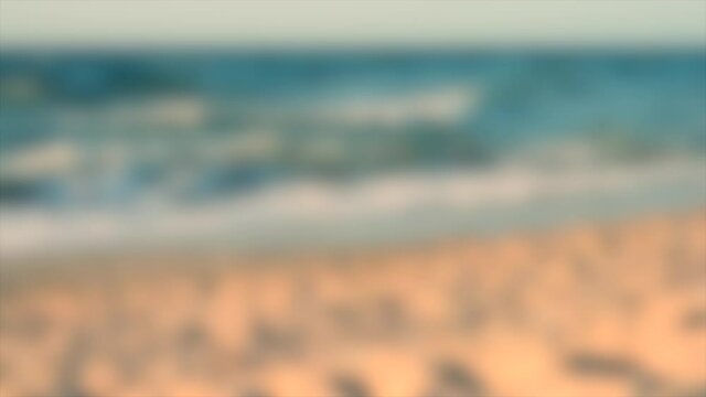 Blurred background. Waves of Black sea lapping close-up on a sandy beach
