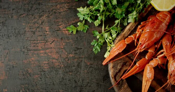 Boiled crayfish on a wooden cutting board.