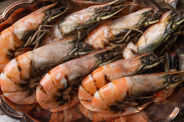 Close-up view of large cooked shrimps on a metal dish. Seafood concept. Organic meal. Horizontal format.