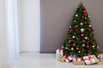 Fototapeta na wymiar Christmas tree pine with gifts new year decor interior of the holiday postcard