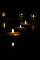Fototapeta na wymiar three candles are burning on a dark background. High quality photo