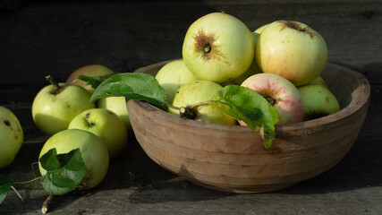 Green organic healthy apples in wooden bowl on  board. Healthy food