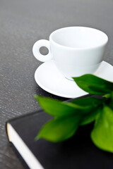 leaf on book, glasses and teacup