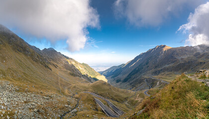 Transfagarasan road in Romania - curved amazing motorway through the mountains from Transylvania in a cloudy day with spectacular sky