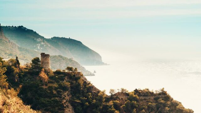 Costal landscape with watchtower. Torre Del Pino, tower on cliffs of Maro Cerro Gordo Natural Park, near Maro and Nerja, Malaga province, Costa Del Sol, Andalusia, Spain. Tourist attraction.