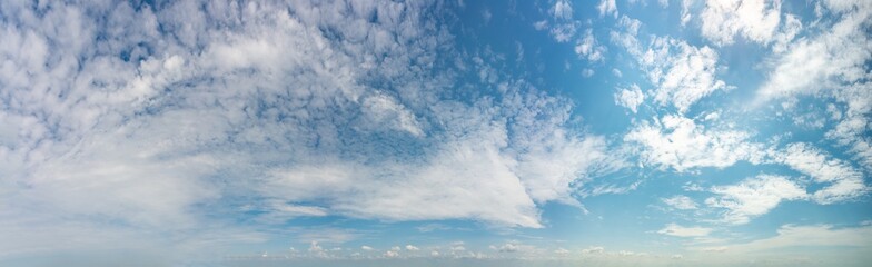 Fantastic clouds against blue sky, panorama