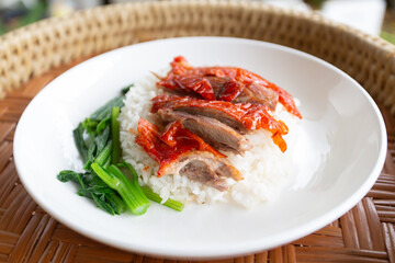 Roasted duck on rice.