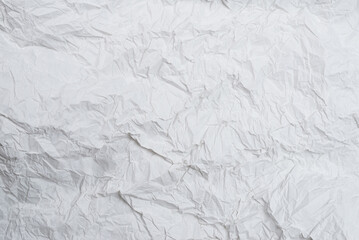 Crumpled white paper background.