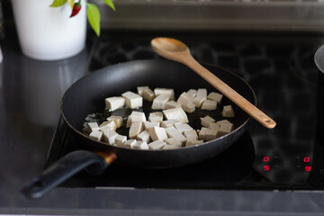 Close up cooking and frying tofu on pan making lunch or dinner indian or thai food