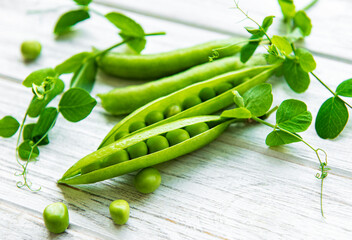 Green peas  on a white wooden background.  Healthy food background.