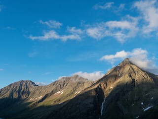 view from Nurnberger Hutte mountain hut at valley with sharp mountain peaks at Stubai hiking trail, Stubai Hohenweg, Summer rocky alpine landscape of Tyrol, Stubai Alps, Austria