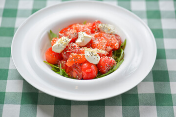 Tomato and salmon salad with cheese and spices. Traditional Italian cuisine, Italian concept.
