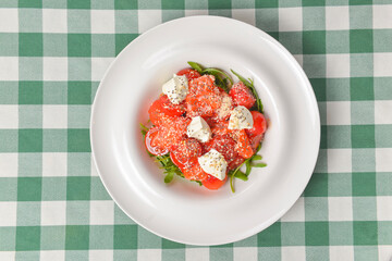Tomato and salmon salad with cheese and spices. Traditional Italian cuisine, Italian concept.