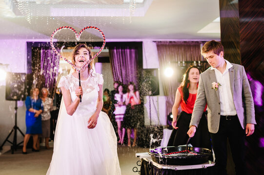 Beautiful wedding couple blowing bubbles. Bride and Groom at Soap Bubble Show.