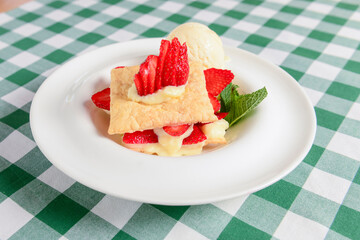 Napoleon cake with strawberries and vanilla ice cream. Italian cuisine concept, traditional Italian summer dessert.